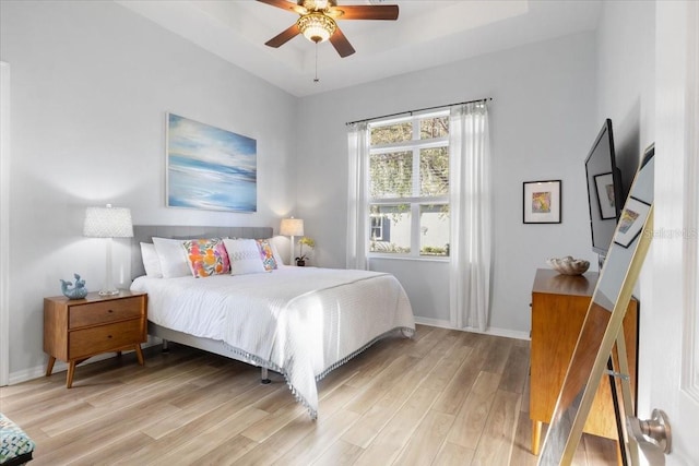 bedroom with ceiling fan and light hardwood / wood-style flooring