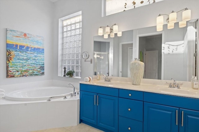 bathroom with shower with separate bathtub, tile patterned flooring, and vanity