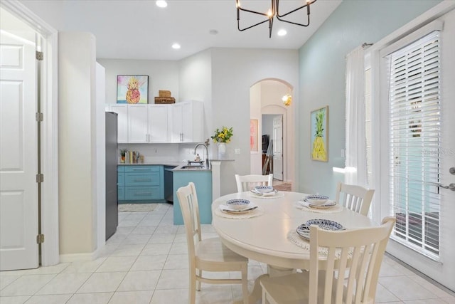 dining space featuring sink and light tile patterned floors