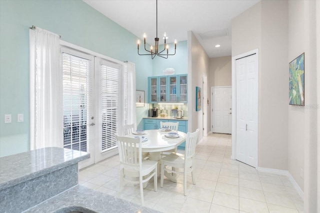 tiled dining room featuring an inviting chandelier