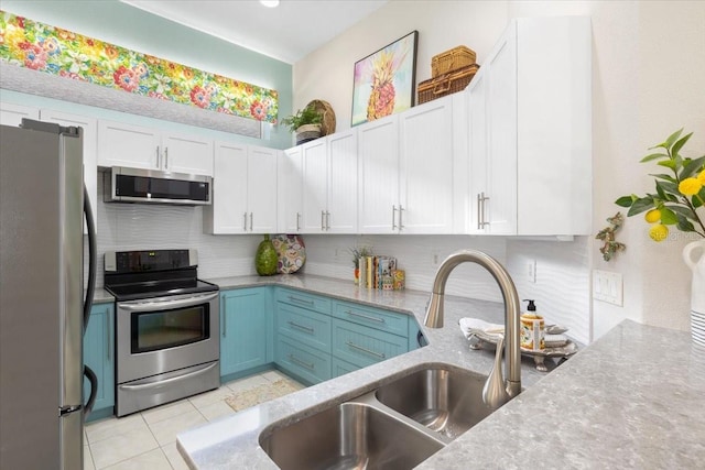 kitchen featuring white cabinets, appliances with stainless steel finishes, and sink