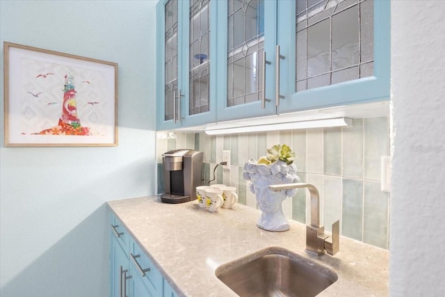 kitchen featuring blue cabinets and sink