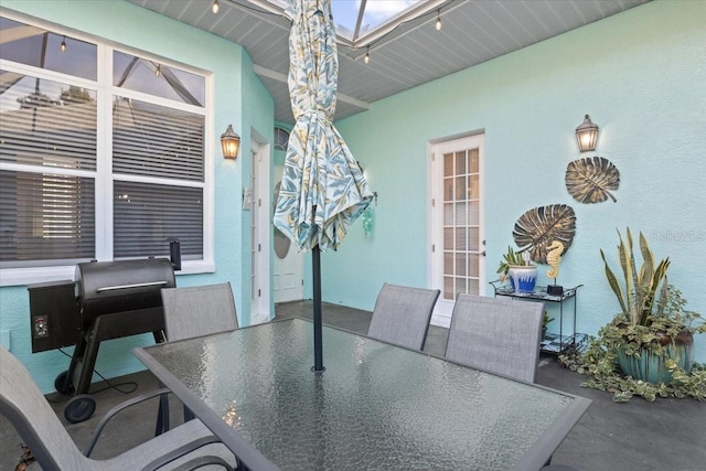 dining area featuring a skylight and concrete floors