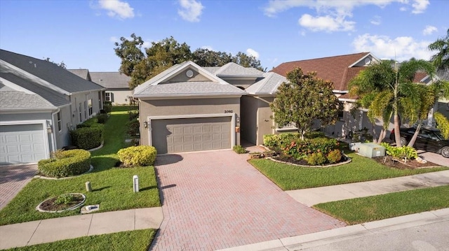 view of front of property with a garage and a front lawn