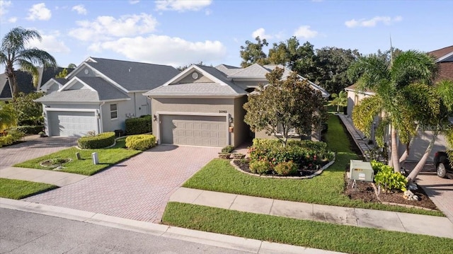 view of front of home featuring a front lawn and a garage