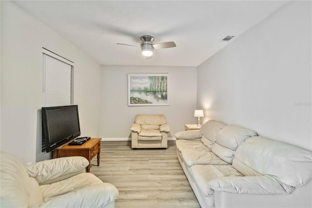 living room with light hardwood / wood-style floors and ceiling fan