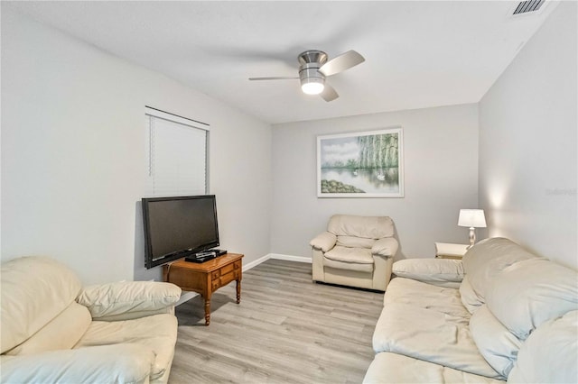 living room with light wood-type flooring and ceiling fan