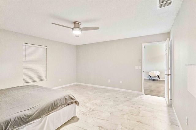 bedroom featuring a textured ceiling and ceiling fan