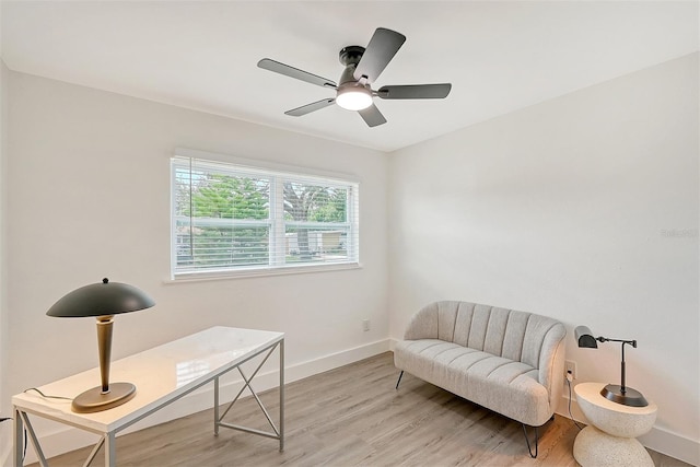 sitting room with light wood-type flooring and ceiling fan