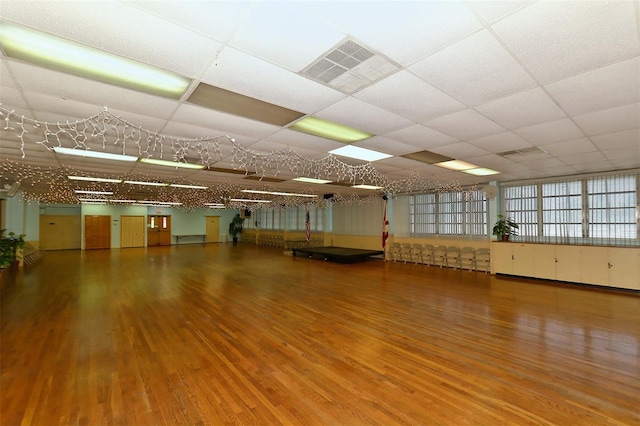 spare room featuring a paneled ceiling and hardwood / wood-style floors