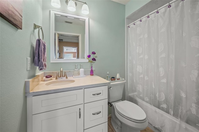 full bathroom featuring vanity, shower / bath combo with shower curtain, and toilet