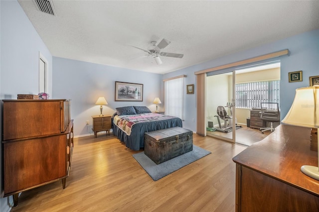 bedroom featuring a textured ceiling, ceiling fan, and light hardwood / wood-style flooring