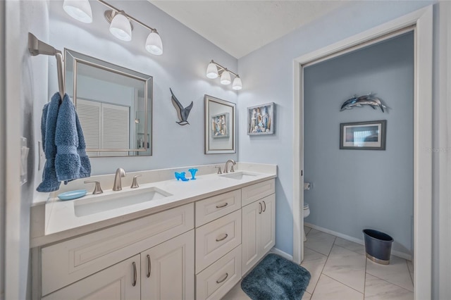 bathroom featuring vanity and toilet