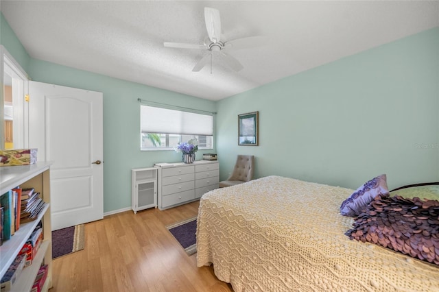 bedroom with light hardwood / wood-style flooring and ceiling fan