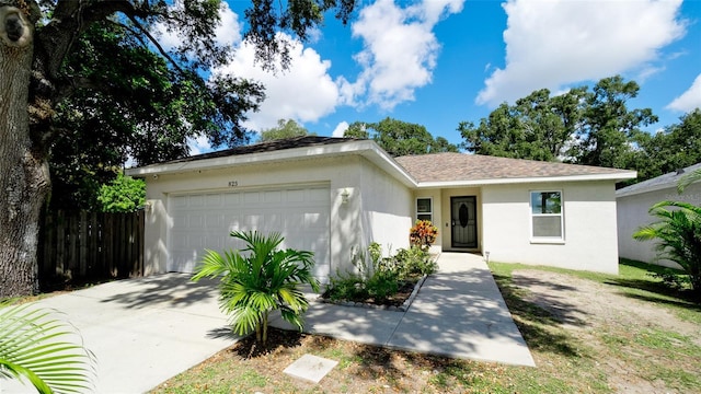 823 32nd Ave E, Bradenton, FL 34208 - ranch-style house featuring a garage, stucco siding, concrete driveway, and fence