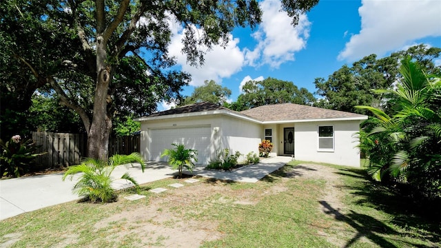 ranch-style house with a garage and a front yard