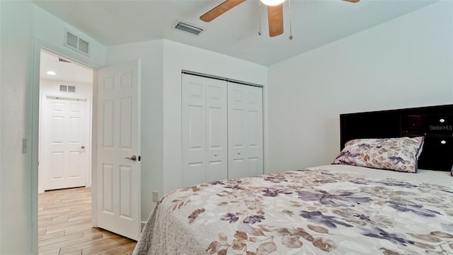 bedroom featuring ceiling fan, light wood-type flooring, and a closet