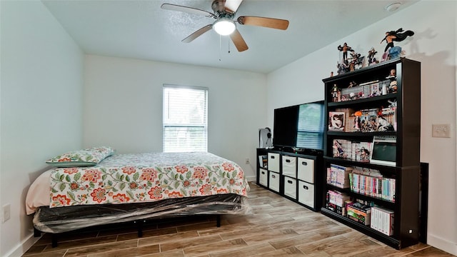 bedroom with wood-type flooring and ceiling fan