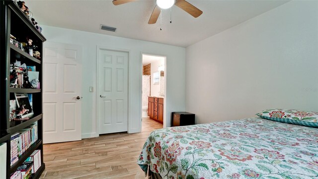 823 32nd Ave E, Bradenton, FL 34208 - bedroom featuring light wood finished floors, connected bathroom, and a ceiling fan
