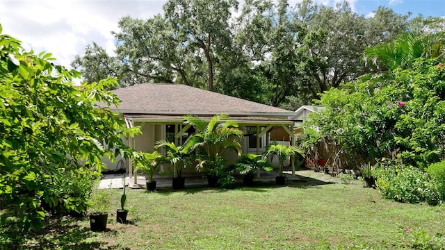 823 32nd Ave E, Bradenton, FL 34208 - back of property featuring a yard and a shingled roof
