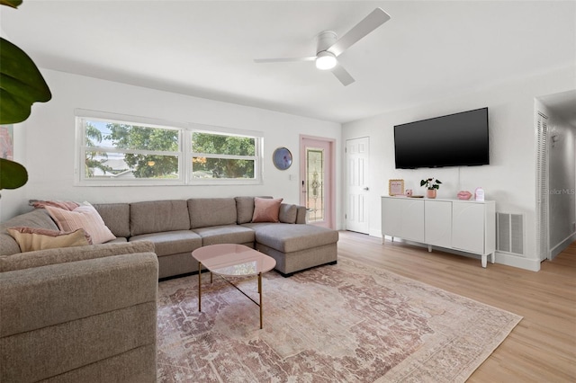 living room with ceiling fan and hardwood / wood-style flooring