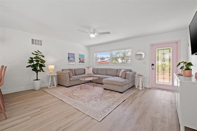 living room with light hardwood / wood-style floors and ceiling fan