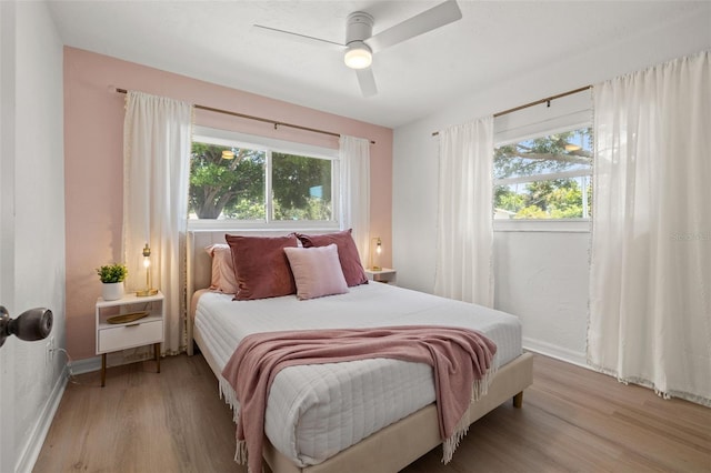 bedroom with ceiling fan and light hardwood / wood-style flooring