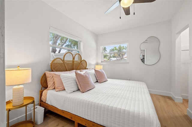 bedroom with light wood-type flooring and ceiling fan