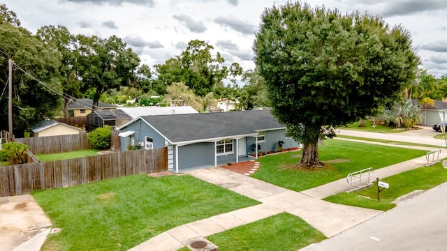 single story home with a garage and a front lawn