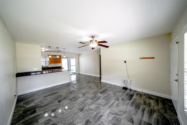 unfurnished living room with ceiling fan