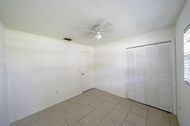 unfurnished bedroom with a closet and ceiling fan