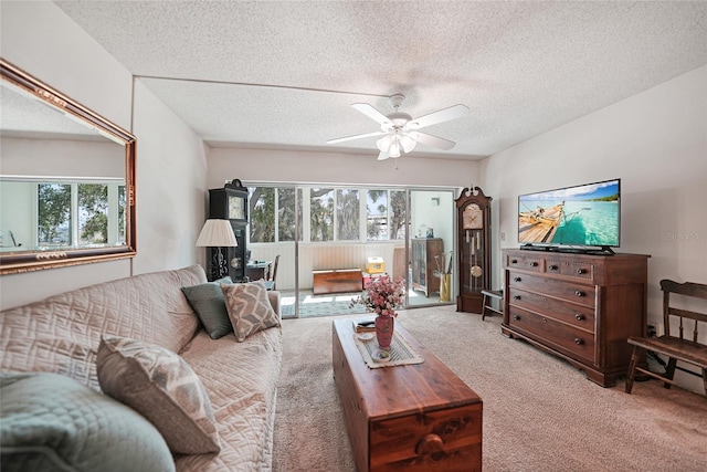 living room with carpet floors, a textured ceiling, and ceiling fan