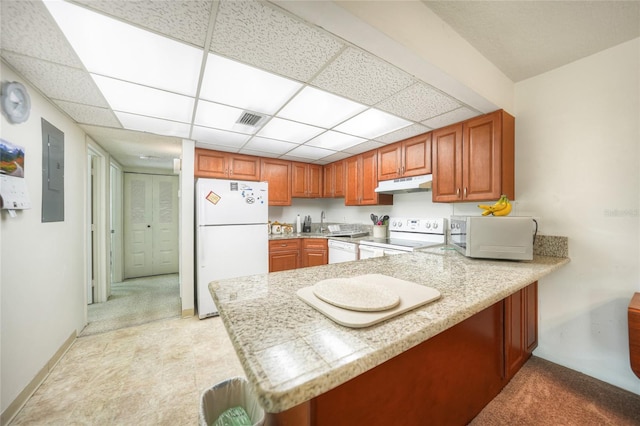 kitchen featuring electric panel, a paneled ceiling, kitchen peninsula, and white appliances