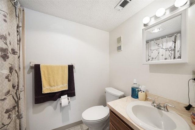 bathroom with a shower with curtain, a textured ceiling, vanity, and toilet