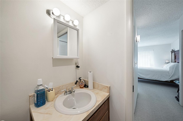 bathroom featuring a textured ceiling and vanity