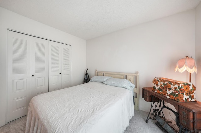 carpeted bedroom with a textured ceiling and a closet