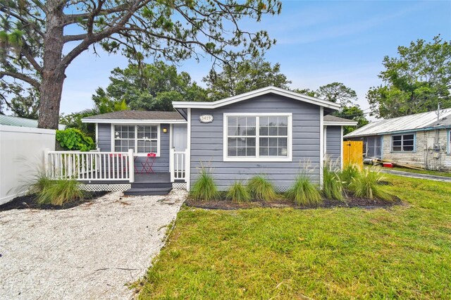 3419 19th St E, Bradenton, FL 34208 - view of front of property with a front lawn, fence, and a deck
