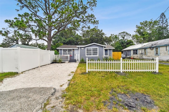 rear view of property featuring a yard