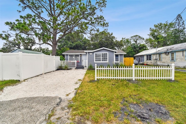 3419 19th St E, Bradenton, FL 34208 - view of front of house with fence private yard, a front yard, and a deck