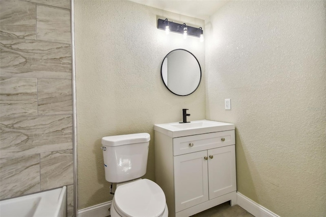 3419 19th St E, Bradenton, FL 34208 - bathroom with baseboards, toilet, vanity, and a textured wall