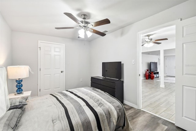 bedroom featuring wood-type flooring and ceiling fan