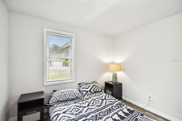 bedroom featuring hardwood / wood-style floors and multiple windows