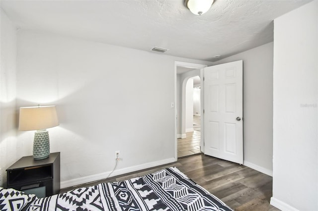 3419 19th St E, Bradenton, FL 34208 - unfurnished bedroom with arched walkways, wood finished floors, visible vents, and baseboards