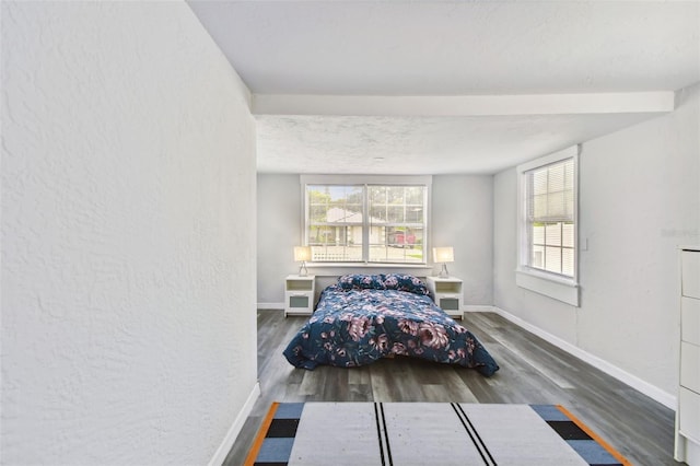 unfurnished bedroom featuring a textured ceiling and dark hardwood / wood-style floors