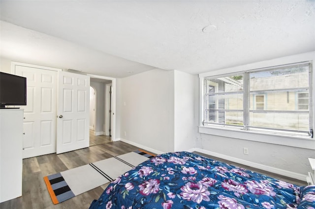 unfurnished bedroom with dark hardwood / wood-style flooring