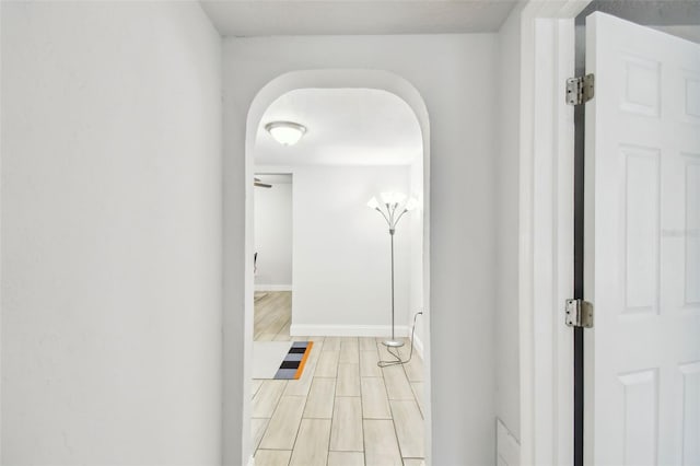 3419 19th St E, Bradenton, FL 34208 - hall with arched walkways, wood tiled floor, and baseboards