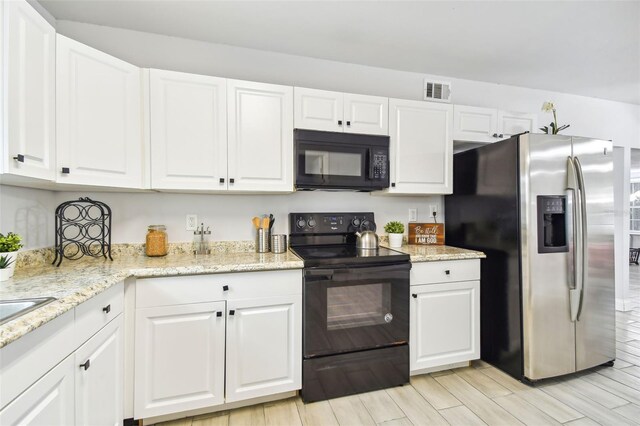 3419 19th St E, Bradenton, FL 34208 - kitchen with wood tiled floor, visible vents, light stone countertops, black appliances, and white cabinetry