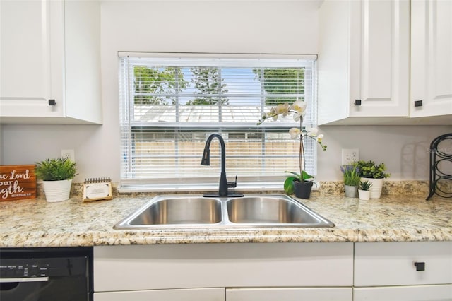 kitchen featuring light stone countertops, white cabinetry, dishwasher, and sink