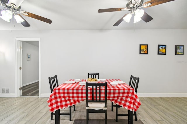 dining space featuring ceiling fan and light wood-type flooring