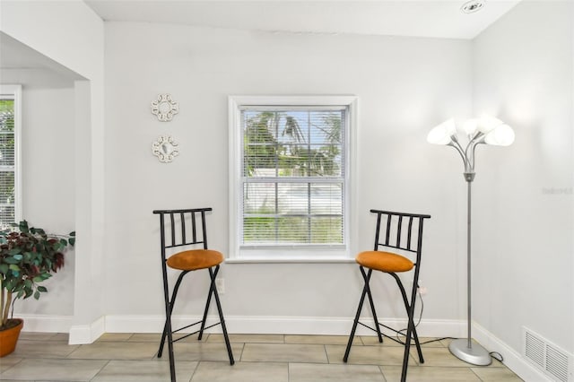 sitting room with light tile patterned floors and plenty of natural light